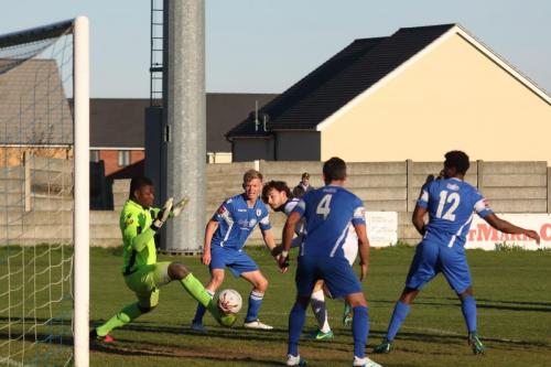 Harry Ottaway (white) scores the third Enfield goal