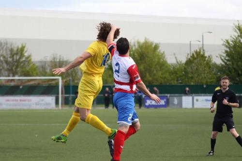 Enfields Harry Ottaway (L) challenges Craig Pope