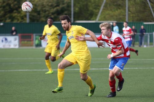 Enfields Harry Ottaway (L) holds off Charlie Dickens