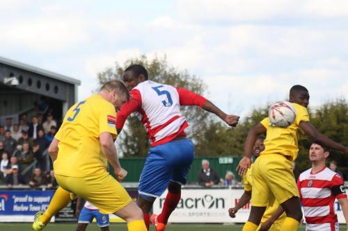 Enfields Mark Kirby (yellow 5) beats Ibrahima Sonko to a header  The ball was cleared but only as far as Kirby who set up Harry Ottaway for the second goal