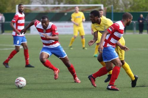 Enfields Ricky Gabriel (yellow) wins a free kick for a body check by Jared Small
