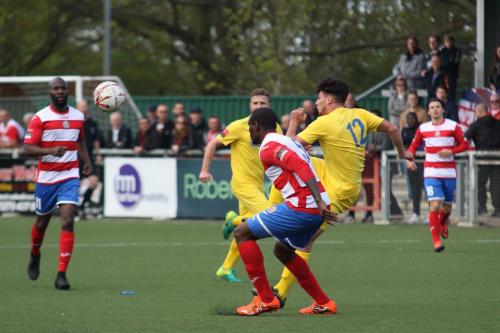 Enfields Samir Bihmoutine (yellow) plays the ball to the wing