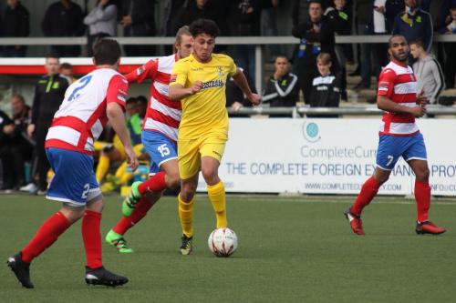 Enfields Samir Bihmoutine (yellow) runs at the defence with Tommy Fagg in pursuit