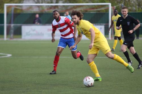 Harlows Fabion Simms (L) looks closely as Harry Ottaway plays the ball forward