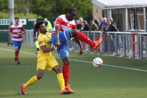 Harlows Ibrahima Sonko (R) clears from Dernell Wynter