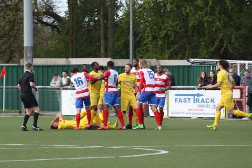 Tempers flare after a clash between Scott Shulton (on floor) and Harlows Tommy Fagg (15) resulting in yellow cards for the pair