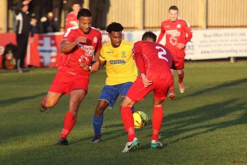 Enfields Dernell Wynter challenges by Shaun Preddie (L) and Josh Webb