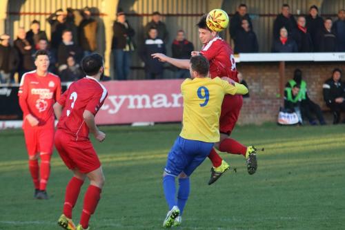 Harrows David Taylor (R) wins a header against Billy Crook