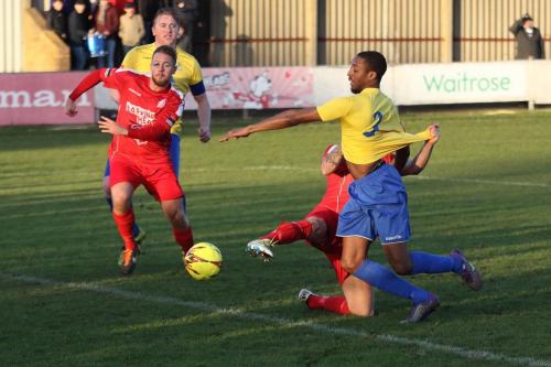 Harrows Lewis Driver is lucky not to be penalised for pulling Ricky Gabriels shirt, preventing him from reaching the ball