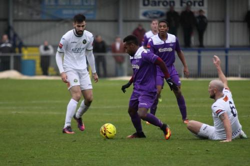 Enfields Bobby Devyne takes the ball from Lee Molyneaux (R)