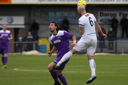 Havants Lee Molyneaux (R) heads clear from Harry Ottaway