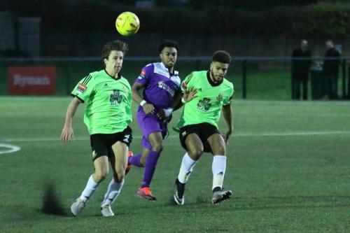 Enfields Dernell Wynter is squeezed out by Spencer McCall (L) and Josh Passley