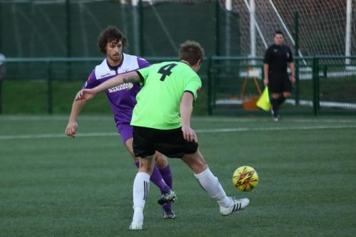 Enfields Harry Ottaway plays the ball past Bradley Hewitt (R)