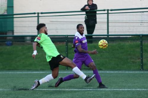 Enfields Ricky Gabriel (R) crosses as Josh Passley tries to block