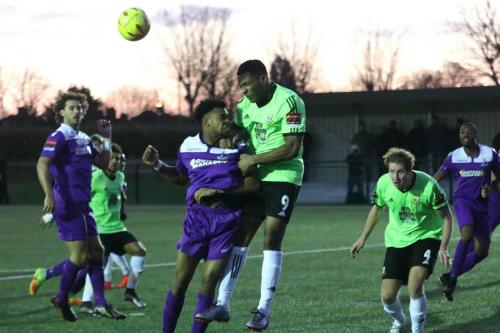 Hendons Kezie Ibe heads clear from Dernell Wynter