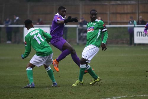 Enfields Percy Kiangebeni shoots over the bar under pressure from Mo Sagaf (L) and Paul Semakula