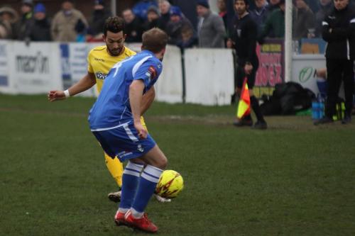 Enfields Tyler Campbell (yellow) and Lowestofts Andrew Fisk