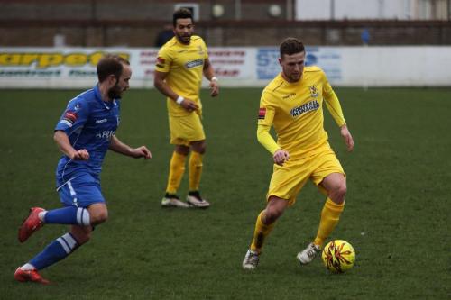 Lowestofts Andrew Fisk (L) challenges Billy Crook