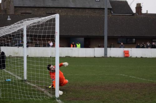 Lowestofts Jake Jessup is beaten by Billy Crooks penalty to put Enfield ahead