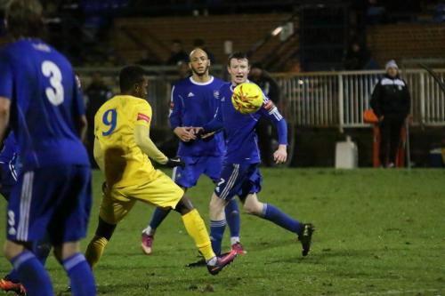 Enfields Bobby Devyne (yellow) lines up a shot that is deflected wide