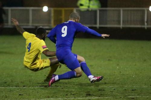 Enfields Harold Joseph (yellow) challenges Lloyd Macklin