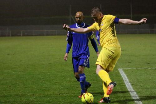 Enfields Mark Kirby (R) clears from an unconcerned-looking Steve Sutherland