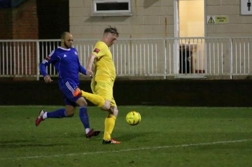 Enfields Mark Kirby (yellow) clears from Lloyd Macklin