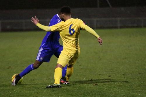Enfields Nathan Livings (yellow) challenges Orlando Smith