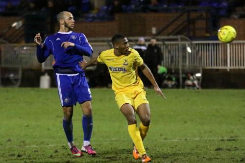 Mets Lloyd Macklin (L) and Enfields Jonathan Muleba