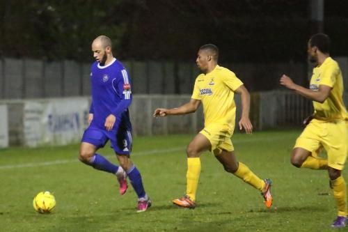 Mets Lloyd Macklin and Enfields Jonathan Muleba and Ricky Gabriel (R)