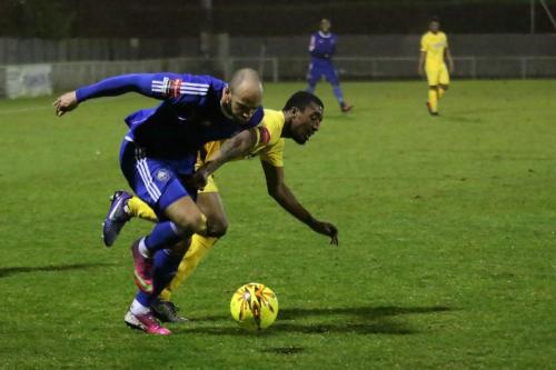 Mets Lloyd Mackln (blue) muscles his way past Ricky Gabriel
