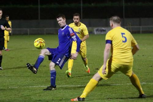 Mets Luke Robertson (blue) lifts the ball into the box