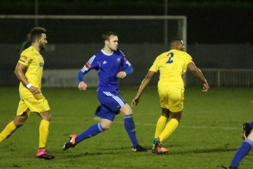 Mets Sam Williams (blue) plays the ball inside