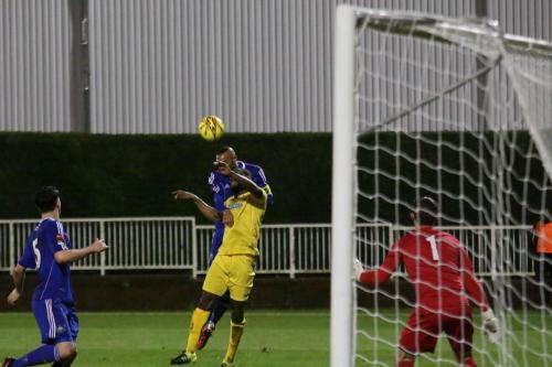 Mets Steve Sutherland wins a header against Harold Joseph but is penalised for climbmng
