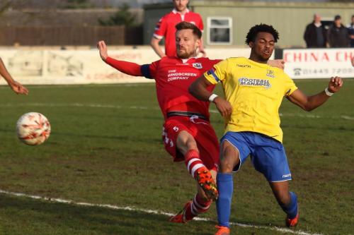 Enfields Dernell Wynter (yellow) gets to the ball just ahead of Ian Miller but shoots narrowly wide