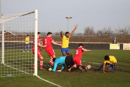 Karl Oliyide appeals for a penalty against Joe Whight (15) but the referee didnt notice him scoop the ball clear with his hand