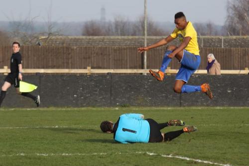 Needham keeper Danny Gay beats Karl Oliyide to a long ball