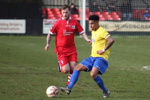 Needhams Billy Clark (red) and Enfields Nathan Livings