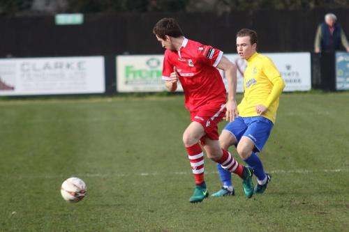 Needhams Daryl Coakley (red) and Enfields Mickey Parcell