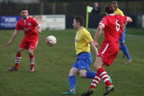 Needhams Keiran Morphew (6) clears from Brad Quinton