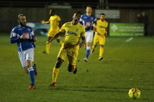 Angels Jack Parter (L) beats Karl Oliyide to the ball and plays it back to his keepeer