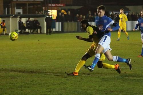 Angels Tom Parkinson (blue) does just enough to stop Karl Oliyide getting a clean shot