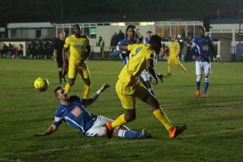 Angels Tom Phipp (blue) challenges Karl Oliyide