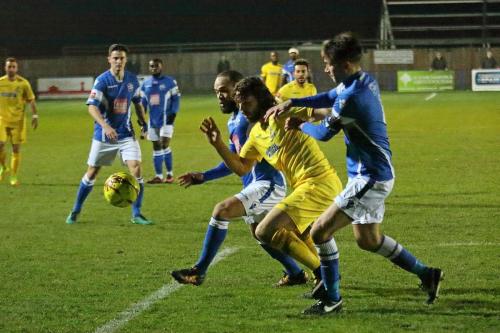 Enfields Harry Ottaway (yellow) challenges Damian Scannell (L) and Tom Parkinson