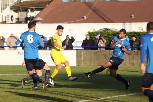Enfields Samir Bihmoutine (yellow) sees his shot blocked by Tanasheh Abrahams