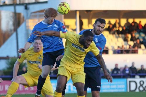 Wingates Ahmet Rifat (R) and Ryan Sellers challenge Harold Joseph