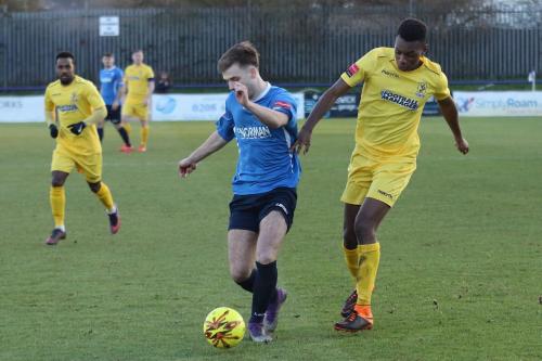 Wingates Alfie Young (L) and Enfields Karl Oliyide