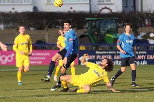 Wingates Claudiu Vilcu (blue) and Enfields Harry Ottaway