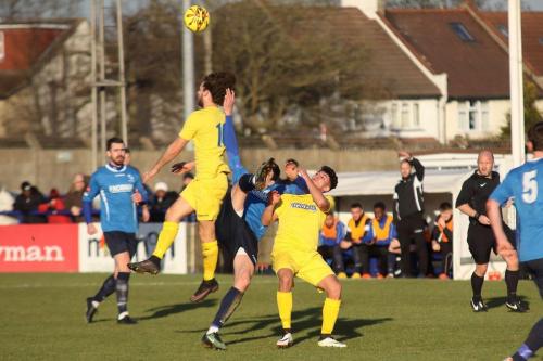 Wingates Claudiu Vilcu (blue) challenged by Harry Ottaway (L) and Samir Bihmoutine