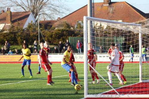 All eyes on the ball as Karl Oliyides (L) header hits the foot of the post